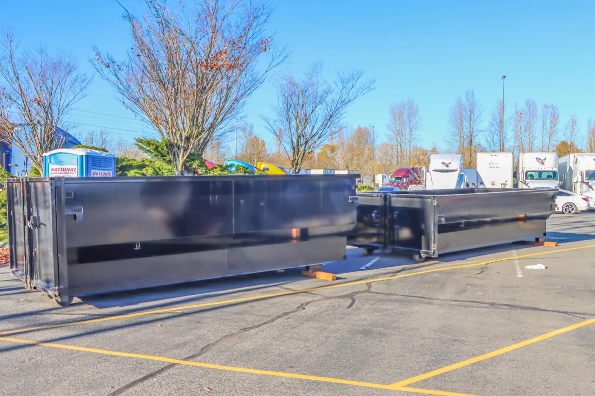 Professional dumpster rental service with roll-off container on residential driveway in La Presa